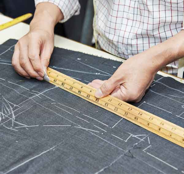 Hohenstein apparel engineer measuring a pattern