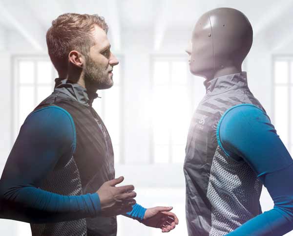 Person and testing manikin facing each other in the same clothes