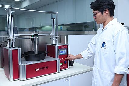 Hohenstein Hardlines Testing Lab in Shanghai Hohenstein lab technician testing the scratch resistance of a baking dish