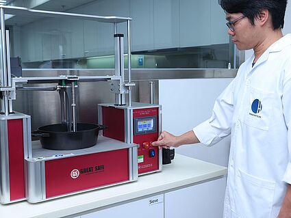 Hohenstein Hardlines Testing Lab in Shanghai Hohenstein lab technician testing the scratch resistance of a baking dish
