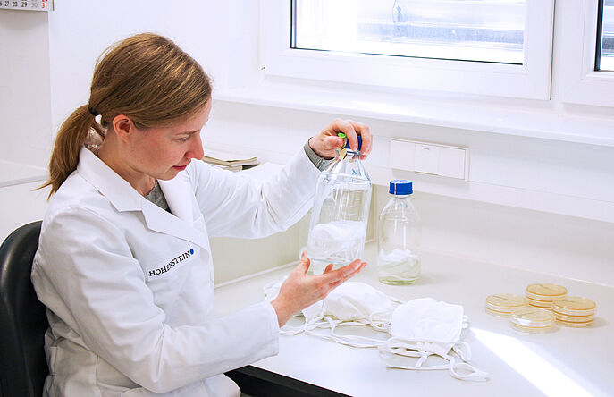 Hohenstein employee testing face masks in lab