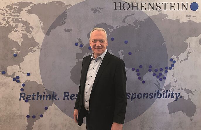 Professor Dr. Stefan Mecheels standing in front of Hohenstein map of locations