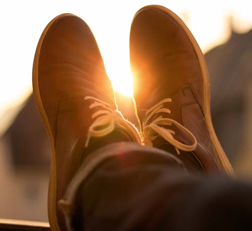 Leather shoes on person with crossed legs