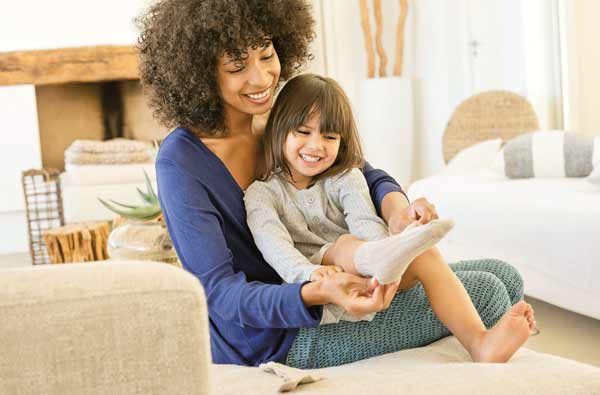 Mom and child sitting on carpeted floor