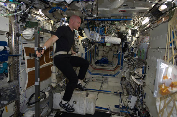 Alexander Gerst wearing SpaceTex t-shirt while exercising on the ISS