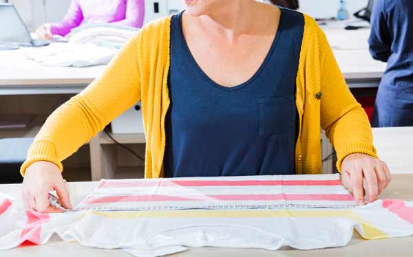Seamstress measuring garment for conformity