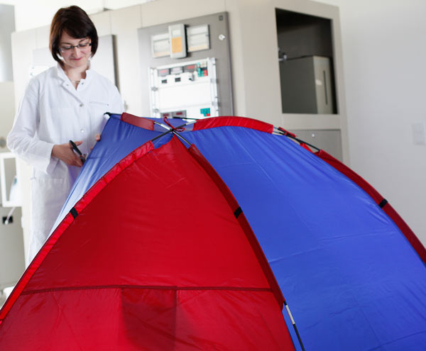 Technician in lab with tent to be tested